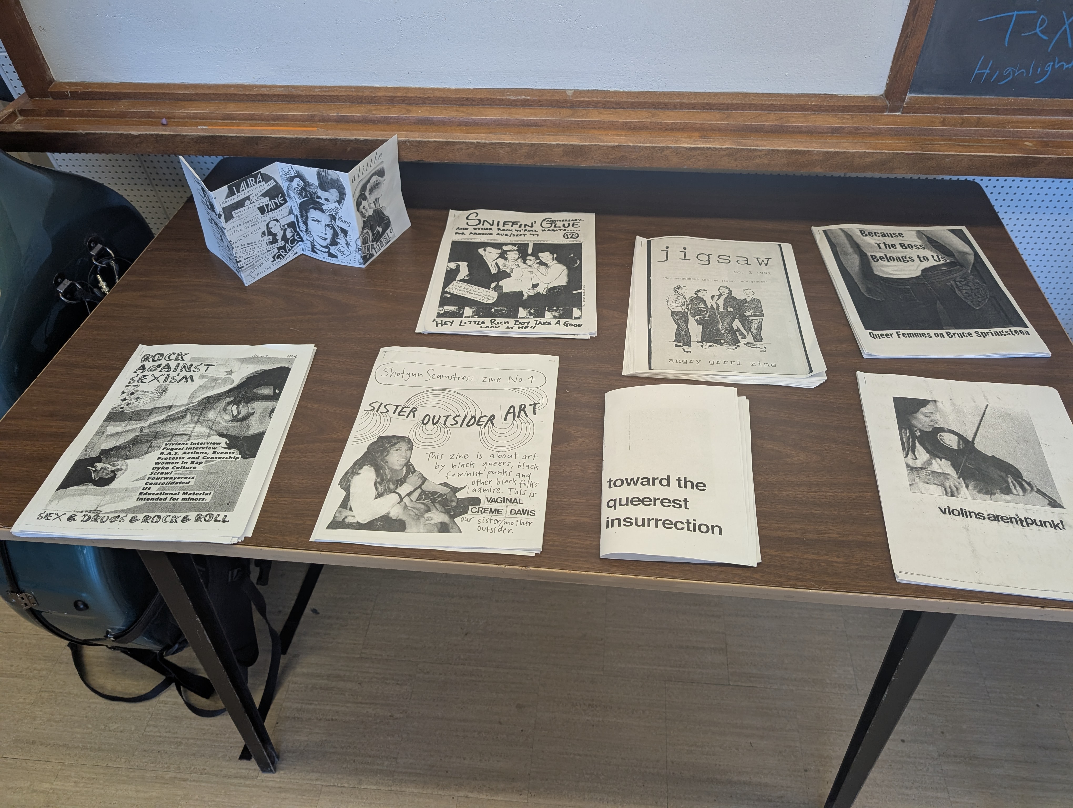 A selection of zines on a table in a classroom