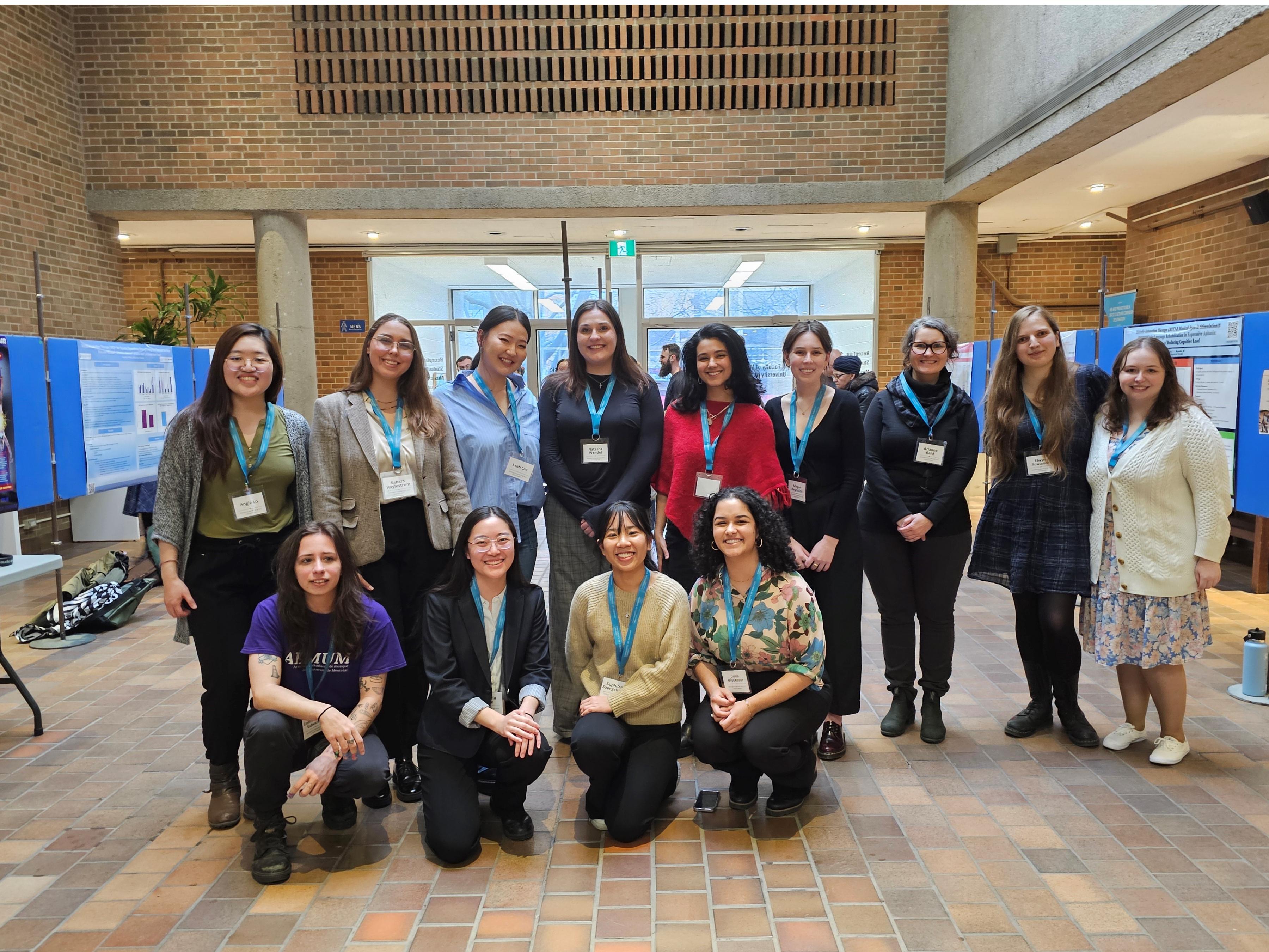 group photograph of graduate showcase participants smiling after the event has finished.