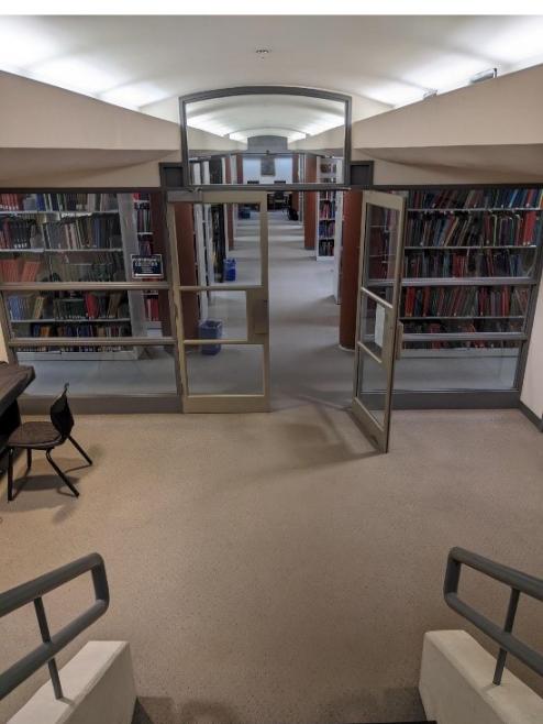 Descending the stairs to the lower level of the library