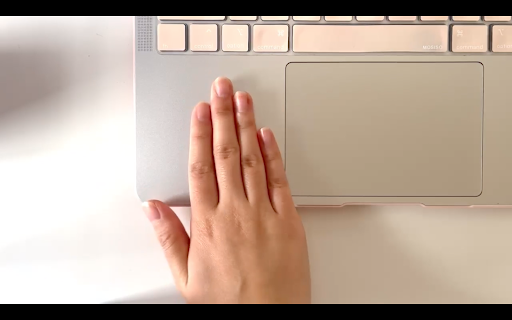 Graphic of hand tapping on laptop beside mousepad.